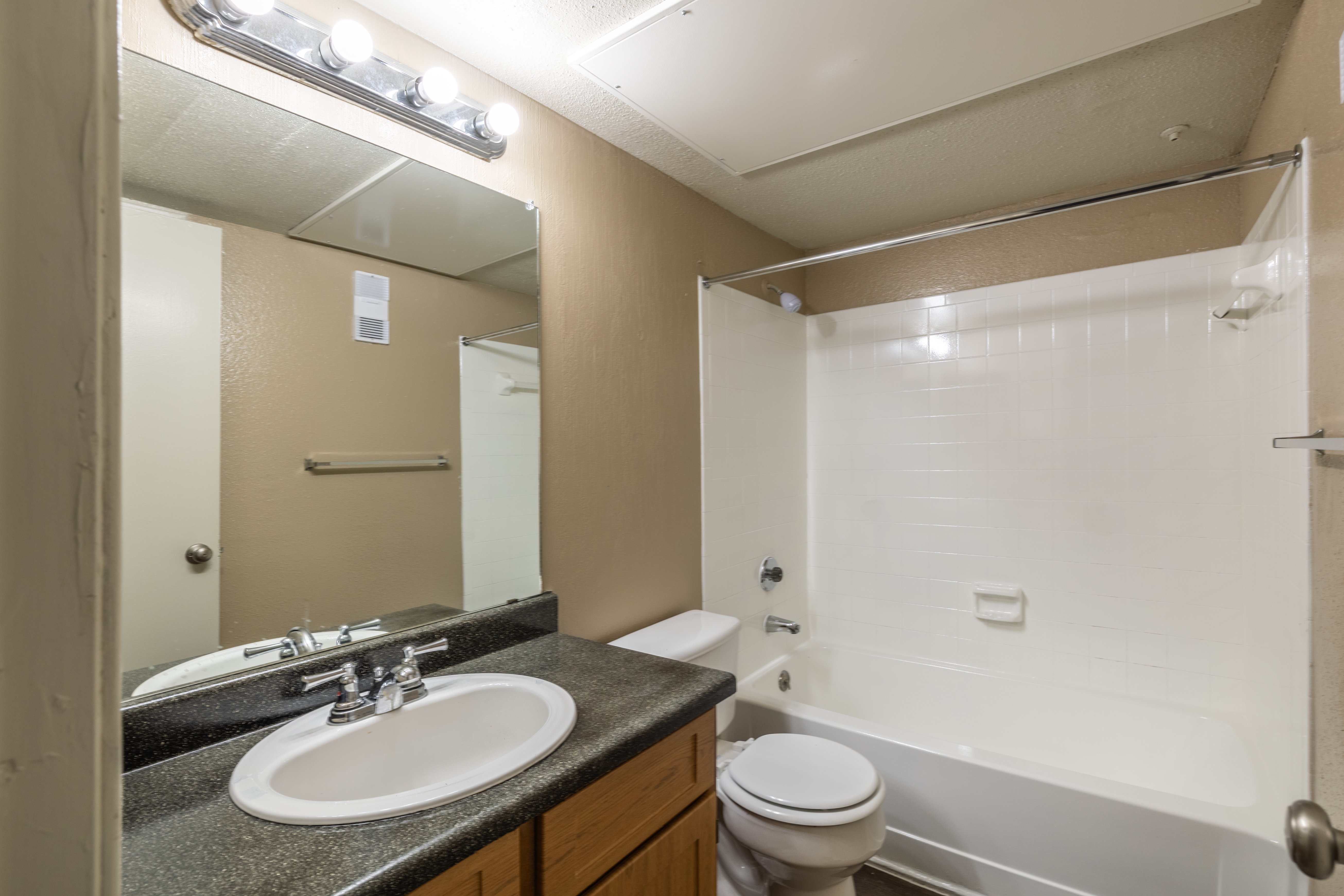 A bathroom with a sink, toilet, and bathtub.